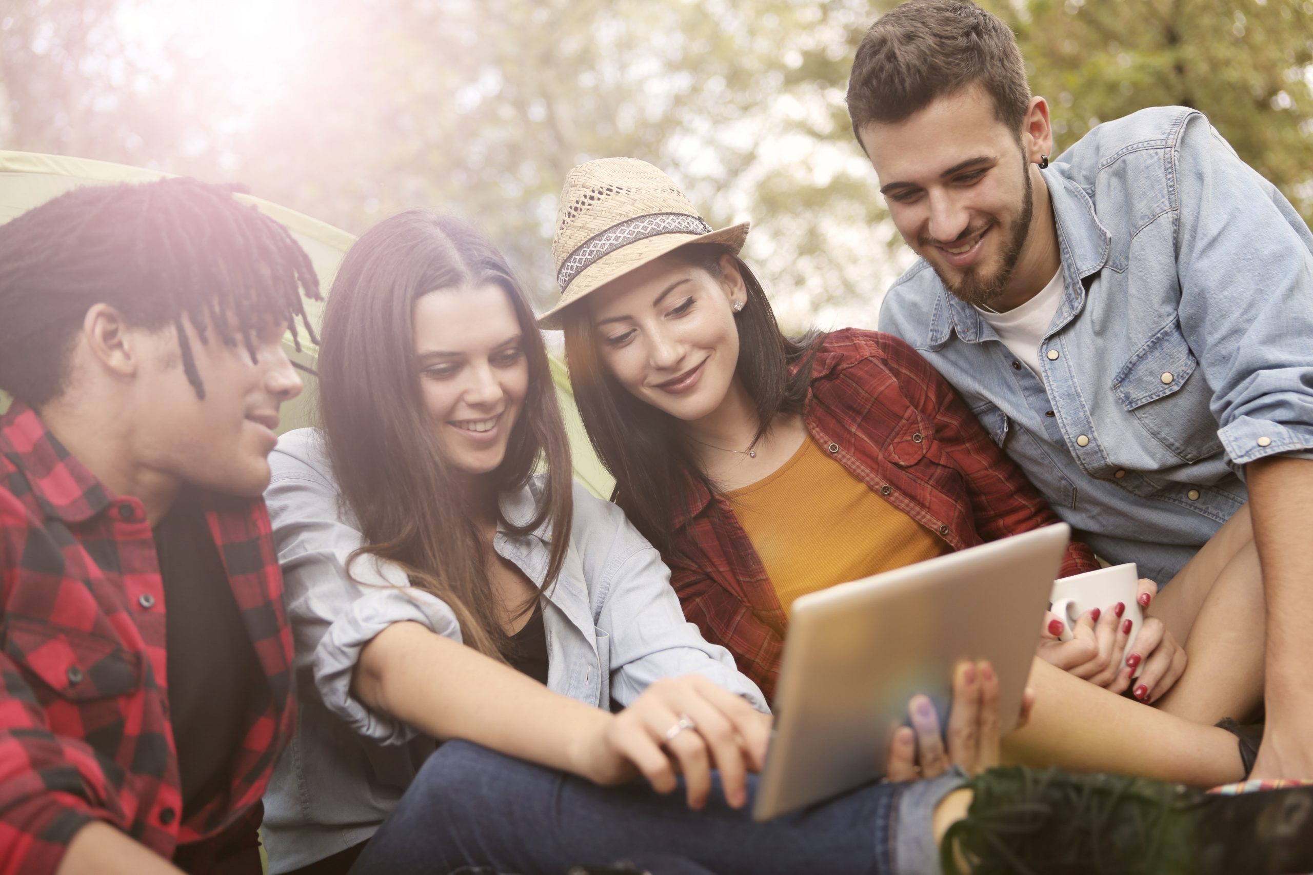 Friends sitting together looking at tablet